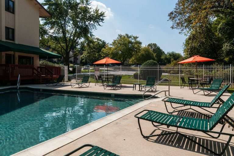 The Metropolitan East Goshen - swimming pool with lounge chairs and tables